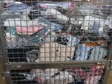 a metal cart with many items in it in a warehouse