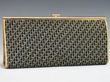 a black and gold clutch bag with a chain design