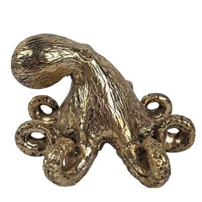 an image of a gold octopus statue on a white background