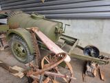 an old military vehicle that is sitting in a garage