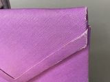 a close up of a purple purse on a table