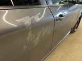 a car with graffiti on the side of it parked in a garage