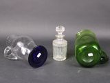 three glass bottles sitting next to each other on a table