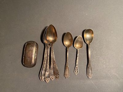 five spoons and a spoon rest on a table