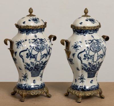 two blue and white vases sitting on top of a table next to each other