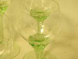 three wine glasses sitting on a table with a white table cloth
