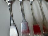 five spoons and two spoons on a table