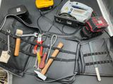 a tool belt with tools in it sitting on a table
