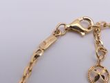 gold plated bracelet with a bird charm on a chain