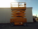 a yellow scissor that is parked in front of a building