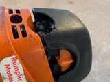 a chainsaw that is sitting on the ground