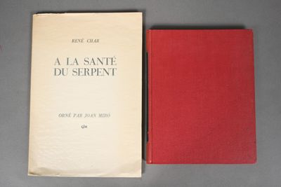 an old book sitting on top of a table next to a red book