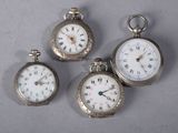 three silver pocket watches with roman numerals and roman numerals on them