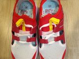 pair of red and white shoes with yellow bows on them
