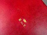 a red book with a gold crown on it