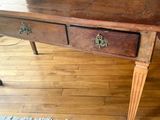 a wooden table with two drawers on it on a hard wood floor