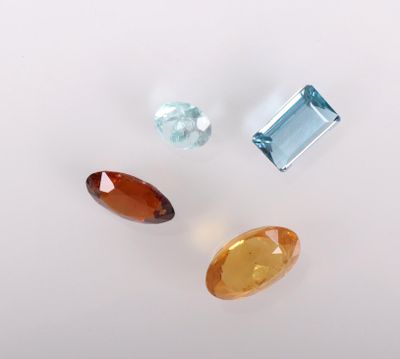trois pierres précieuses de couleurs différentes posées sur une surface blanche