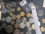 a lot of coins on the table next to a calculator