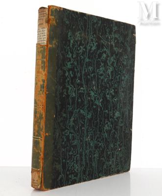 an old book sitting on top of a white table next to a white wall