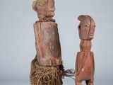 two wooden figurines of a man and a woman