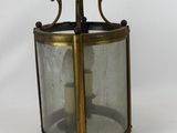 an old fashioned brass lantern with a candle inside of it