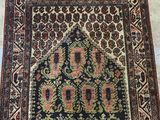 a black and red rug sitting on top of a wooden floor