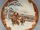 an orange and white plate with a painting of a man and a dog