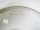 a close up of a white plate with writing on it