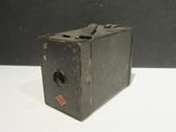 an old camera sitting on a white table