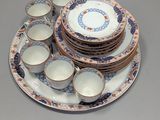 a lot of plates and cups sitting on a table