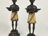 pair of bronze figurines of a woman reading a book and a man reading a book