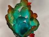 a glass vase that has a bunch of small birds inside of it