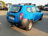 a small blue car that is parked in a parking lot