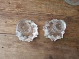 pair of clear glass candlestick holders on a wooden table