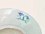 a blue and white plate with a bird on it