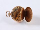 an image of a close up of a pocket watch on a white surface