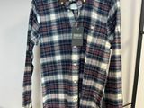 une chemise suspendue à un portant dans un magasin de vêtements