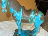 a blue statue of a horse that is on a table