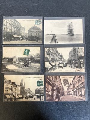 four postcards of old photos of a city street and buildings