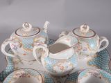 a tea set on a tray with cups and saucers