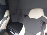 two seats in the back of a van with a tv