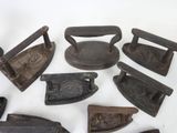 many different types of old irons on the table