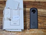 a box and a remote control on a wooden table