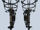 pair of antique wall sconces with ornate designs on each of them
