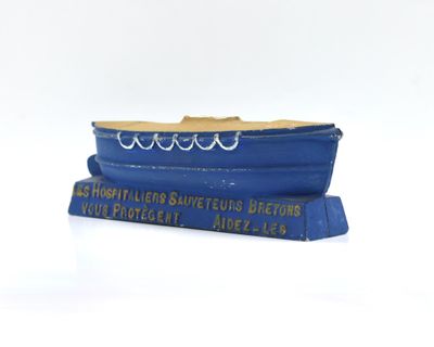 a blue boat that is sitting on top of a book