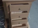 a small wooden chest of drawers on a pallet