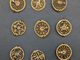 a set of nine gold buttons with ornate designs on them