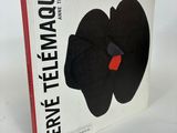 an image of a book with a black flower on it