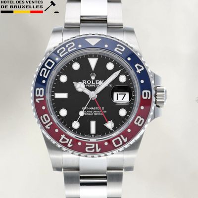 a rolex watch with a red, white and blue bezel