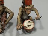 two figurines of monkeys playing musical instruments